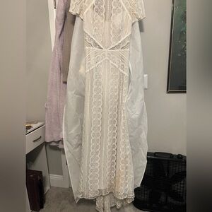 Vintage looking lace with tiny pearl and sequin decorations. Lace cut outs Ivory